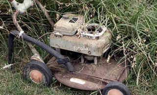 Rusty old Lawnmower with an engine which could be repaired and used.